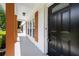 Inviting front door entrance with natural wood columns and shutters, new black hardware, and modern lighting at 2159 Fairburn Sw Rd, Atlanta, GA 30331