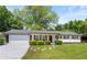 Charming single-story home with a white brick exterior, lovely landscaping, and attached garage at 2159 Fairburn Sw Rd, Atlanta, GA 30331