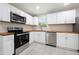 Well-lit kitchen featuring stainless steel appliances and sleek white cabinetry at 2159 Fairburn Sw Rd, Atlanta, GA 30331