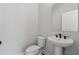 Modern bathroom featuring a pedestal sink and a toilet, perfect for a smaller powder room at 2631 Creekside Nw Dr, Atlanta, GA 30318