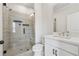 Modern bathroom featuring a glass enclosed shower with gray tiling and a bright vanity area at 2631 Creekside Nw Dr, Atlanta, GA 30318