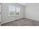 Cozy bedroom featuring soft carpet and a window, creating a peaceful retreat within the home at 2631 Creekside Nw Dr, Atlanta, GA 30318