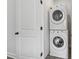 Efficiently stacked washer and dryer set next to a white door, optimizing space in the laundry area at 2631 Creekside Nw Dr, Atlanta, GA 30318