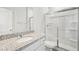 Modern bathroom featuring granite countertops, glass shower doors, and a clean, bright finish at 3633 Squires Park Ln, Loganville, GA 30052