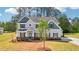 Inviting two-story home with a lush green lawn and classic architectural details at 3633 Squires Park Ln, Loganville, GA 30052