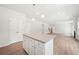 Open-concept living room featuring hardwood floors and a view into the kitchen at 3633 Squires Park Ln, Loganville, GA 30052