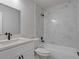 Elegant bathroom features marble tile, modern vanity, and a combination tub and shower at 5383 Biffle Way, Stone Mountain, GA 30088