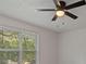 Bedroom showing a ceiling fan, window with blinds, and neutral-colored walls at 5383 Biffle Way, Stone Mountain, GA 30088