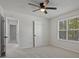 Bedroom featuring neutral carpet, a window, and a ceiling fan for comfort, ready for personalization at 5383 Biffle Way, Stone Mountain, GA 30088