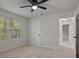 Bedroom with a window, ceiling fan, neutral carpet and paint providing a serene, ready-to-personalize space at 5383 Biffle Way, Stone Mountain, GA 30088