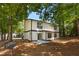 Two-story home with a patio area and wooded backyard at 5383 Biffle Way, Stone Mountain, GA 30088