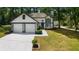 Charming two-story home featuring a two-car garage and a well-kept lawn with mature trees at 5383 Biffle Way, Stone Mountain, GA 30088