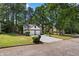 Two-story home featuring a two-car garage and a well-maintained lawn with mature trees at 5383 Biffle Way, Stone Mountain, GA 30088