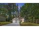 Charming two-story home featuring a two-car garage and landscaped front yard surrounded by mature trees at 5383 Biffle Way, Stone Mountain, GA 30088