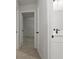 Hallway featuring neutral carpeting, with doorways leading to a bedroom and a bathroom at 5383 Biffle Way, Stone Mountain, GA 30088