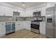 Well-appointed kitchen featuring stainless appliances, sleek countertops, and white cabinetry at 5383 Biffle Way, Stone Mountain, GA 30088