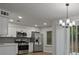 Updated kitchen with stainless appliances, white cabinets, and stylish backsplash at 5383 Biffle Way, Stone Mountain, GA 30088
