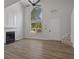 Spacious living room featuring high ceilings, a fireplace, and large arched window for natural light at 5383 Biffle Way, Stone Mountain, GA 30088