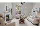 Bright living room featuring a fireplace, high ceilings, and ample seating for entertaining guests at 5383 Biffle Way, Stone Mountain, GA 30088