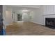 Open-concept living room with hardwood floors, a fireplace, and sliding glass doors to the outdoors at 5383 Biffle Way, Stone Mountain, GA 30088