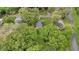 Aerial view of a quaint home nestled amongst mature trees with a verdant lawn at 204 Morris St, Palmetto, GA 30268