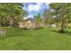 Expansive backyard with mature trees, sheds, and an adjacent home at 204 Morris St, Palmetto, GA 30268