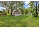 Backyard featuring an outbuilding, grassy lawn, and mature trees at 204 Morris St, Palmetto, GA 30268