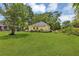 Spacious backyard featuring a large green lawn and mature trees at 204 Morris St, Palmetto, GA 30268