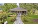 Charming home with a screened-in front porch and a landscaped front yard with a stone pathway at 204 Morris St, Palmetto, GA 30268