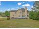 Backyard with a patio, deck and a treeline at 2530 River Run Dr, Dacula, GA 30019