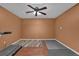 Finished basement featuring a ceiling fan and wood flooring with rubber workout mats at 2530 River Run Dr, Dacula, GA 30019