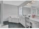 Bathroom featuring a bathtub, vanity, and walk-in shower with black flooring at 2530 River Run Dr, Dacula, GA 30019