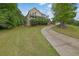 Inviting two-story home featuring a charming front porch and well-manicured lawn and a long driveway at 2530 River Run Dr, Dacula, GA 30019