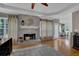 Cozy living room featuring a brick fireplace and hardwood floors, perfect for relaxation and entertaining at 2530 River Run Dr, Dacula, GA 30019