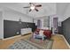 This primary bedroom boasts a wood floor, a four-poster bed, and an area rug at 2530 River Run Dr, Dacula, GA 30019