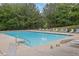 Community pool with lounge chairs and fencing at 2530 River Run Dr, Dacula, GA 30019
