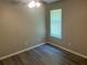 This bedroom features hardwood floors, a window, and a ceiling fan at 6743 Timbers East Dr, Lithonia, GA 30058
