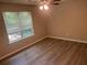This bedroom features hardwood floors, a window, and a ceiling fan at 6743 Timbers East Dr, Lithonia, GA 30058