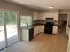 Functional kitchen featuring granite counters, black appliances, and access to the outdoor patio at 6743 Timbers East Dr, Lithonia, GA 30058