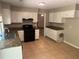 View of kitchen features granite countertops, white cabinets, and black appliances at 6743 Timbers East Dr, Lithonia, GA 30058