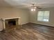 Living room with fireplace and ceiling fan at 6743 Timbers East Dr, Lithonia, GA 30058