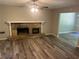 Cozy living room with a stone fireplace and modern floors at 6743 Timbers East Dr, Lithonia, GA 30058