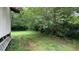 View of backyard with mature trees and grass at 850 Fourth St, Stone Mountain, GA 30083