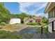 View of the home's backyard, featuring a detached garage and ample parking space at 850 Fourth St, Stone Mountain, GA 30083