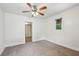Bedroom features neutral carpet, ceiling fan, and window view to the outside at 850 Fourth St, Stone Mountain, GA 30083