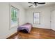 Bright bedroom featuring hardwood floors, ceiling fan, and two windows with natural light at 850 Fourth St, Stone Mountain, GA 30083