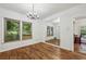 Bright dining room with hardwood floors, natural light, a vintage chandelier, and mirrored wall accents at 850 Fourth St, Stone Mountain, GA 30083
