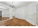 Elegant dining room with hardwood floors, a classic chandelier, and a mirrored wall, enhancing the space at 850 Fourth St, Stone Mountain, GA 30083