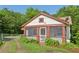 Charming cottage-style home with a screened-in porch and a well-manicured lawn at 850 Fourth St, Stone Mountain, GA 30083