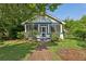 Inviting home with a cozy screened porch and a well-maintained yard, showcasing its charming curb appeal at 850 Fourth St, Stone Mountain, GA 30083